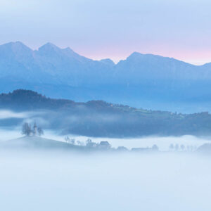 Saint Thomas Church in the mist on an autumn morning in Slovenia. Buy fine art photography prints.